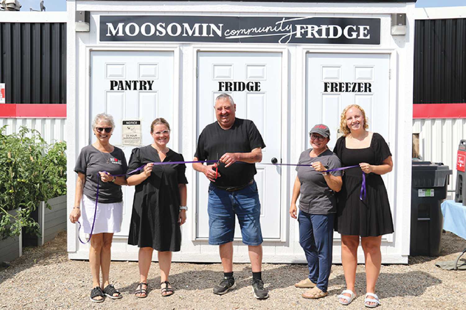 At left, Beryl Stewart, Sam Campbell of the Moosomin Thrift Store and Food Share, Larry Tomlinson, the mayor of Moosomin, Trina Brace, and Jaedyn Moore of the Thrift Store and Food share excited to cut the ribbon for the grand opening of the Community Fridge.